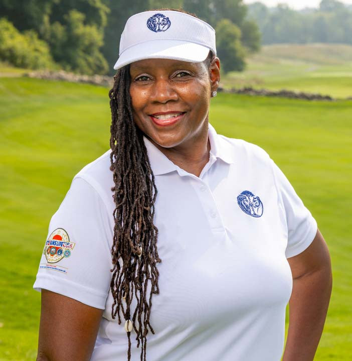 Woman in a white golf shirt with a logo on a golf course