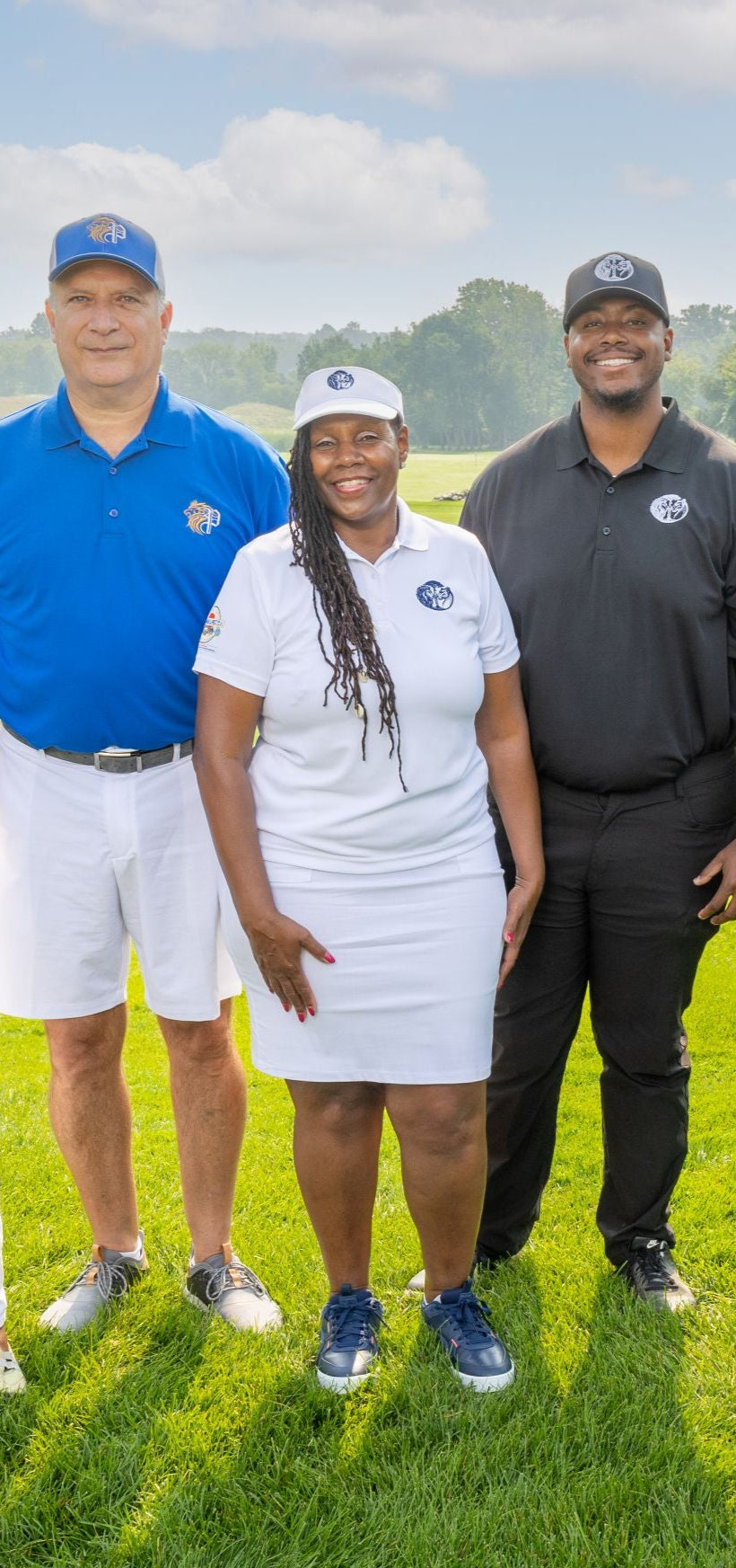 Group of people posing on a golf course in the Power Collection Ready to Wear Line